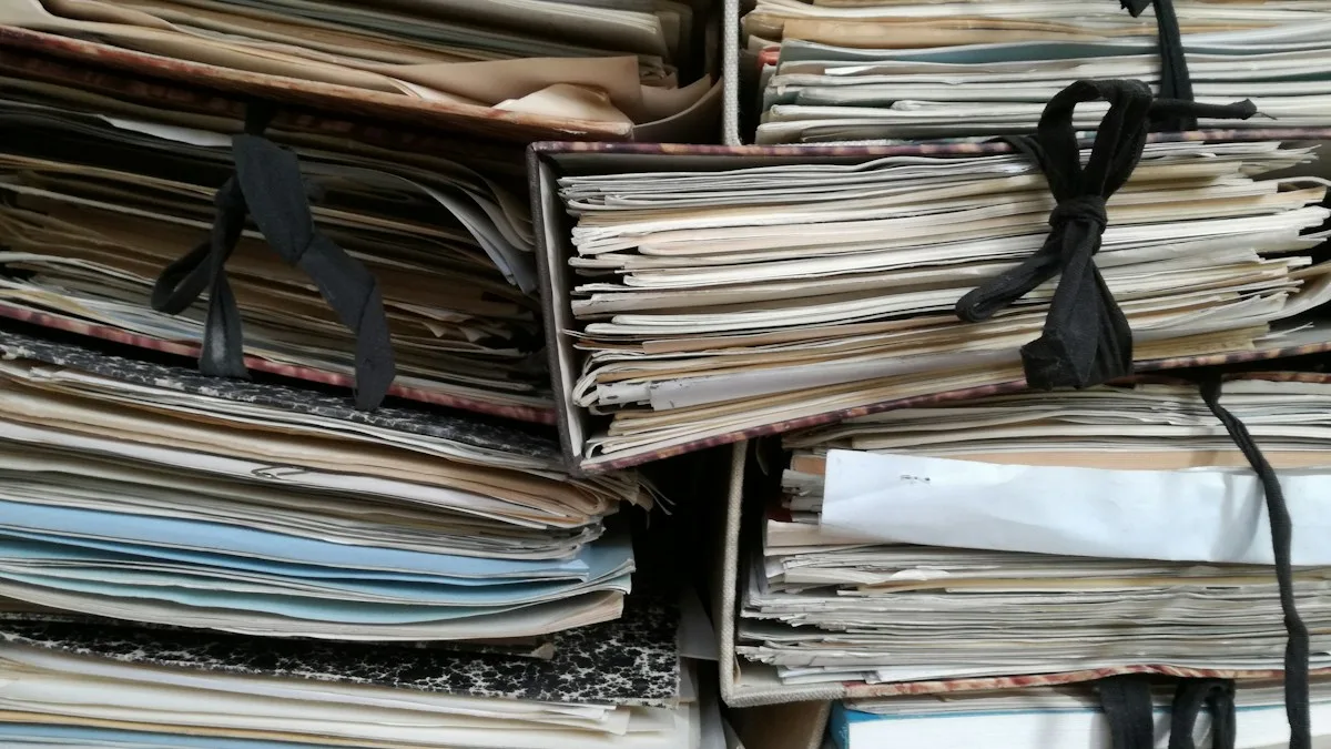 Stacks of old paper files and folders tied with black string