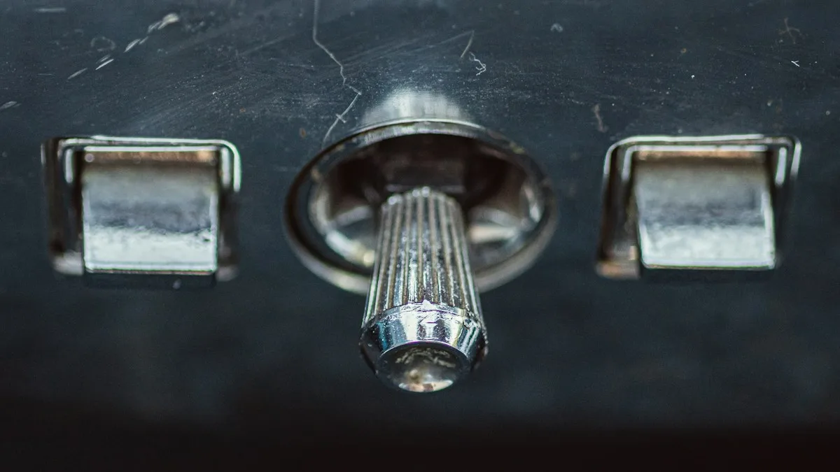 A chrome handle between two latches on a dark metal door
